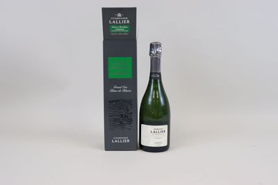 the bottle of wine is next to the box on the table