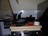pots and pans sit on a stove top in a kitchen