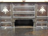 a very old wooden desk with a lot of drawers
