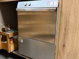 un lave-vaisselle argenté logé à l'intérieur d'un meuble en bois