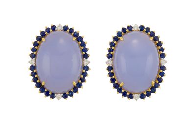 a pair of earrings with blue and white stones