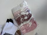 three pairs of socks that are wrapped in plastic