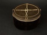 a brown box with a cross on it on a black surface