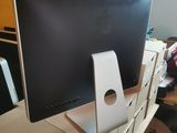 a computer monitor sitting on top of a wooden desk