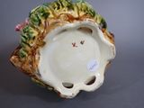 a ceramic figurine of a flower on a table