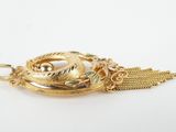a close up of a gold plated pendant with a chain
