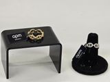 a small table with a ring on it next to a ring holder