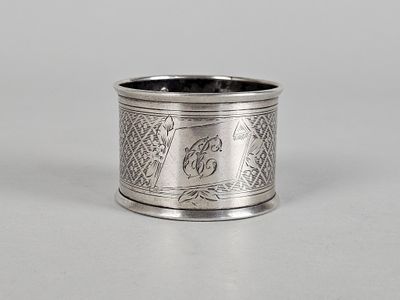 an antique silver napkin ring with a bird on it