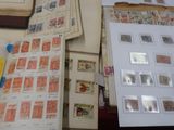 a lot of stamps on a table with a book