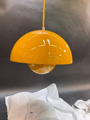 a yellow light hanging over a sink in a kitchen