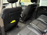 the interior of a car with black leather seats and a yellow sticker on the back
