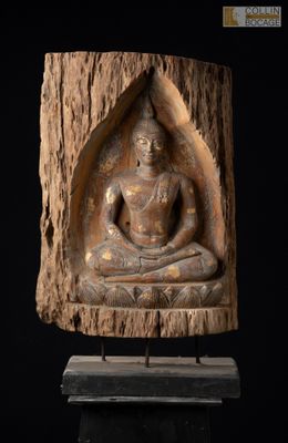 statue d'un Bouddha assis sur une souche d'arbre, sur fond noir