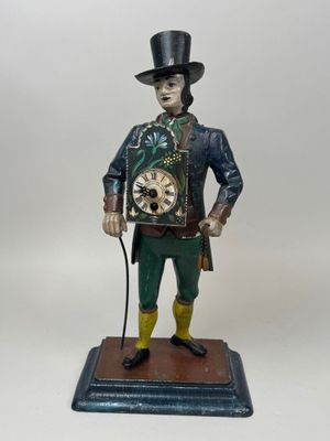 figurine of a man in a top hat and top hat holding a clock