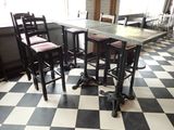 a black and white checkered floor with a table and four chairs