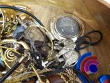 a wooden box filled with assorted jewelry and scissors