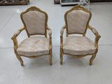 paire de chaises anciennes ornées de dorures et dotées d'accoudoirs rembourrés