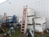 a pile of boxes and ladders in front of a building
