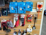 a wall with many different items on it in a store