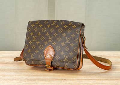 an image of a louis vuitton cross body bag on a table