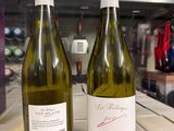 two bottles of wine sitting on a table in a store