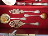 a lot of silver spoons and spoons in a red box