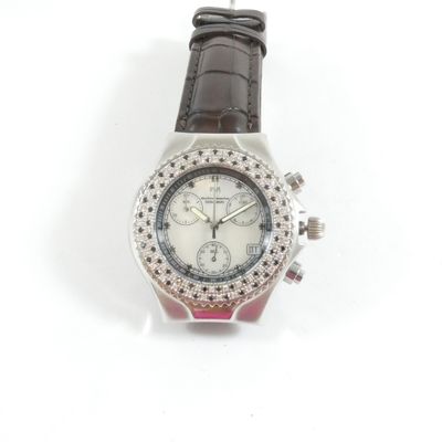 une image d'un gros plan d'une montre-bracelet sur une surface blanche
