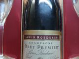 a bottle of champagne sitting next to two wine glasses