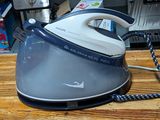 a blue and white steam iron sitting on a wooden table