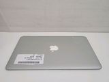 a silver laptop with a sticker on it sitting on a table