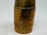 a brass vase that has a label on it