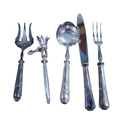 a set of silverware including a knife, fork, spoon and spoon rest