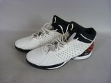 pair of white and black tennis shoes on a white surface