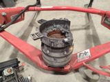 a close up of a red machine with a wren on it