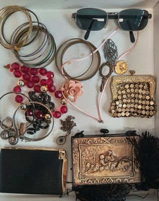 une boîte blanche remplie d'un assortiment de bijoux et d'accessoires