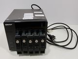 a close up of a small black device with a power cord attached to it