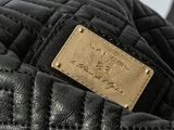 leather jacket with a gold plate on the back of it