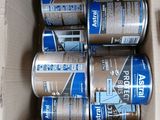 several cans of soda sitting inside of a cardboard box on a table