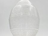 a clear glass vase sitting on top of a white table