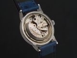a close up of a watch on a black surface