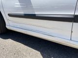 a white car with a black stripe on the side of it