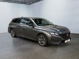 the grey car is parked in a large room with white walls