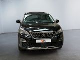 the front view of a black car in a showroom