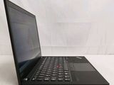 the laptop is open on a white surface with a white background