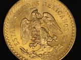 a close up of a gold coin with an eagle on it
