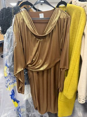 three dresses hanging on a rack in a clothing store