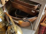 many pots and pans on the shelf in the kitchen