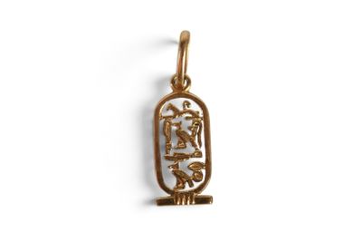 a gold pendant with an egyptian symbol on it