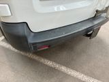 a white van parked in a parking lot next to a building