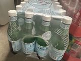 bottles of water are stacked on top of each other in a box