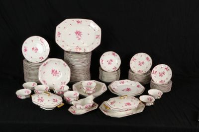 a lot of plates and bowls on a black table